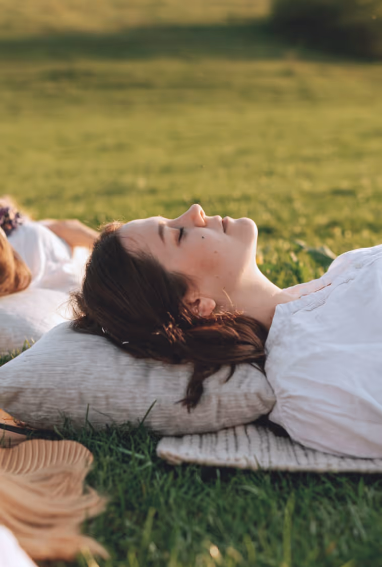 Woman relaxing in the sun on a lawn