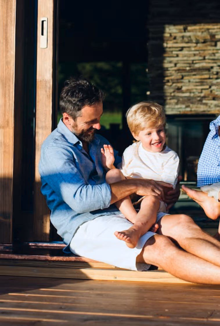 Father and child sitting in the sun
