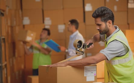 Delhivery worker packing parcels
