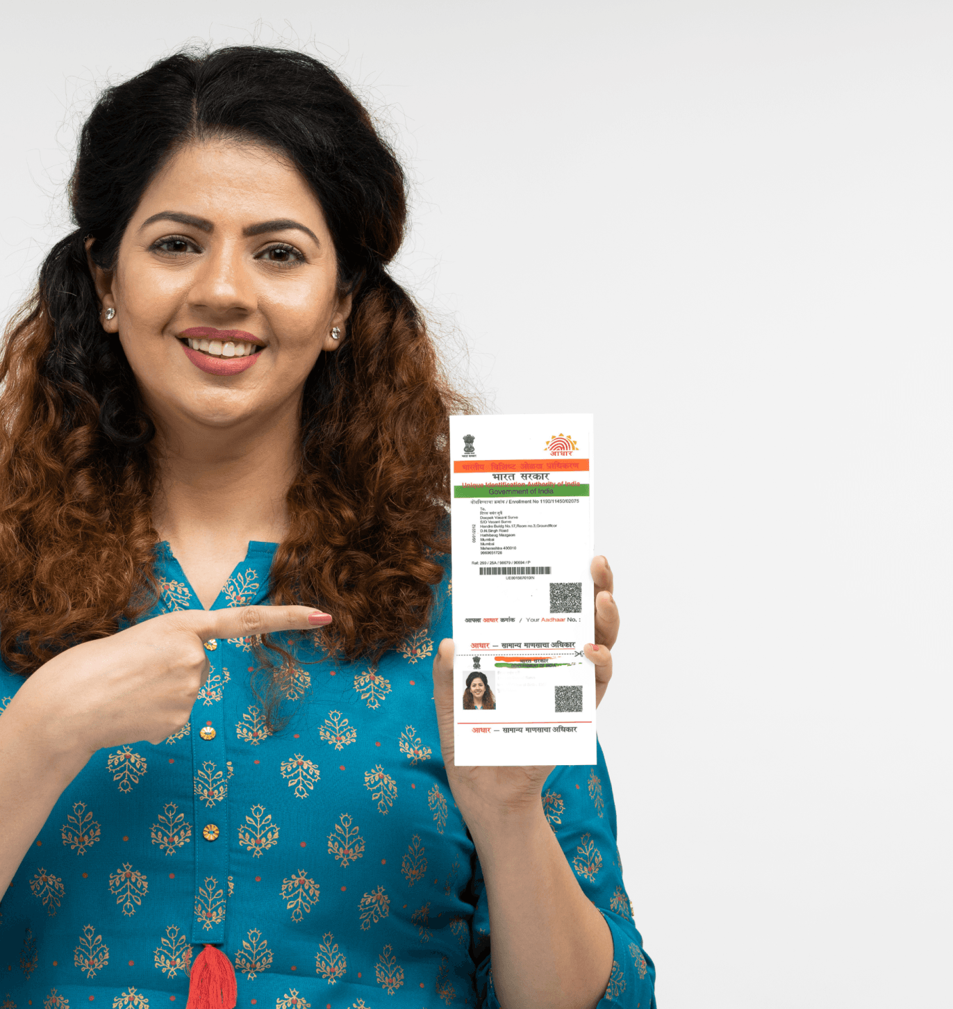 Woman holding an Aadhaar card