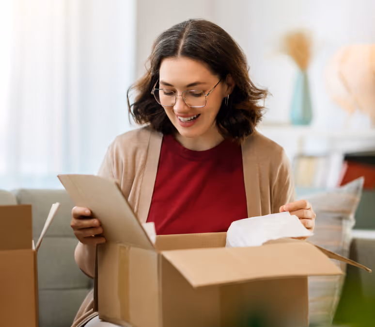 Woman smiling as she unpacks an online order